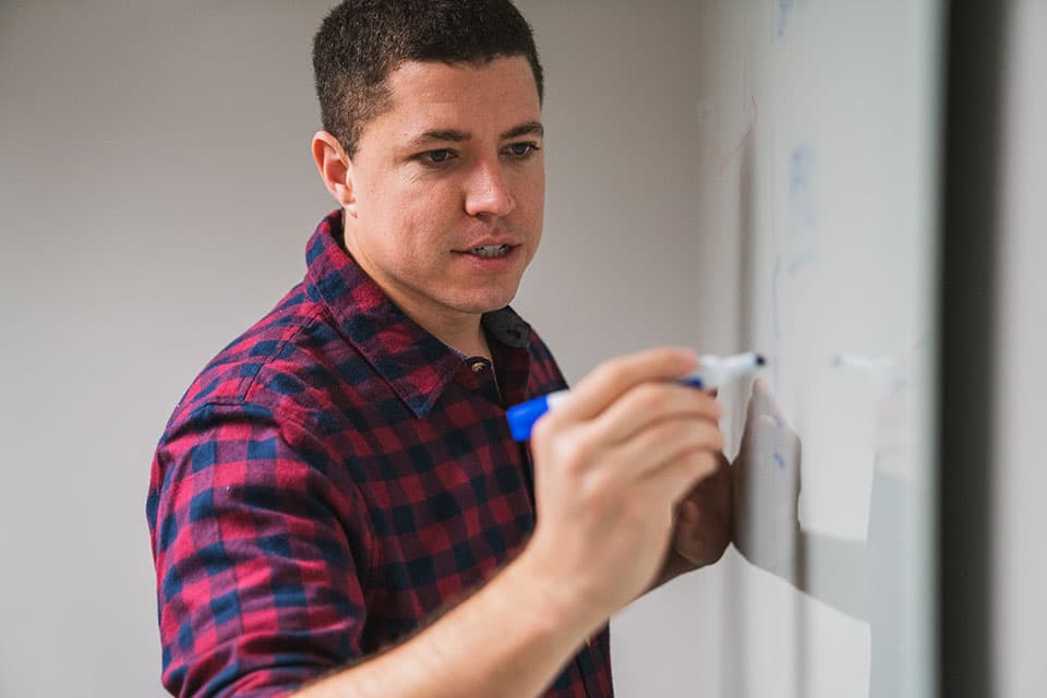 Isaiah McPeak sketching a product strategy on a whiteboard